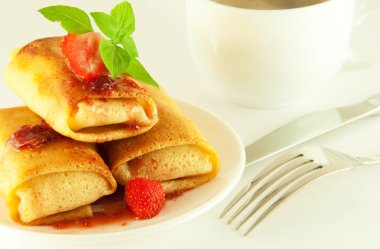 Fritters with strawberry jam and mint and a cup of coffee