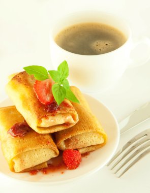 Fritters with strawberry jam and mint and a cup of coffee