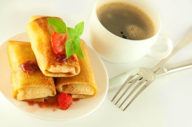 Fritters with strawberry jam and mint and a cup of coffee