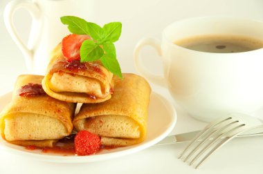 Fritters with strawberry jam and mint and a cup of coffee