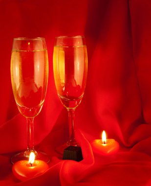 Celebratory table layout with red napkins and candles in the form of heart clipart