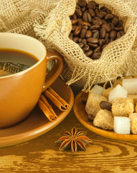 stock image Cup of coffee with chocolates, coffee grains with cinnamon and an anise