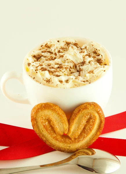 Cake in the form of heart with red ribbon , a cup of coffee — Stock Photo, Image
