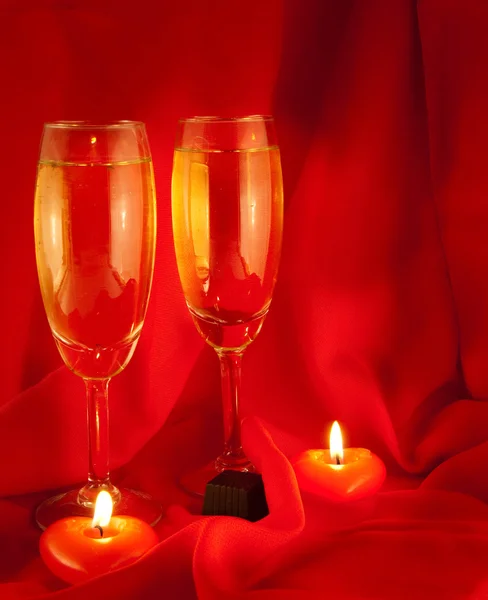 Celebratory table layout with red napkins and candles in the form of heart — Stock Photo, Image