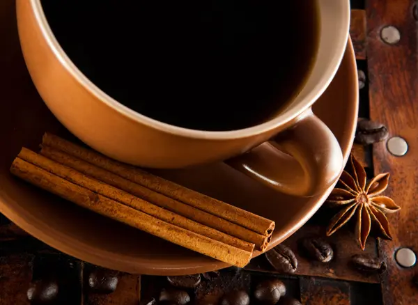 Filiżankę kawy na grange tło, ziaren kawy i cynamon — Zdjęcie stockowe