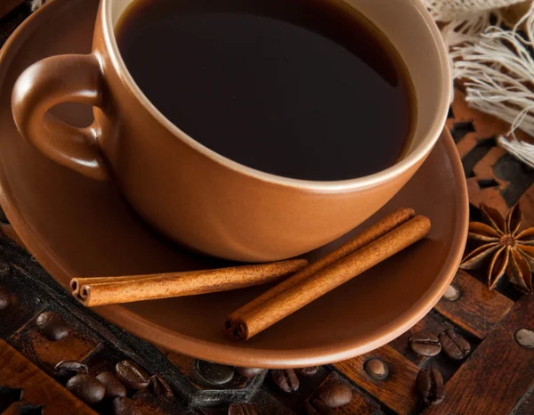 stock image Cup of coffee on grange a background, coffee grains and cinnamon