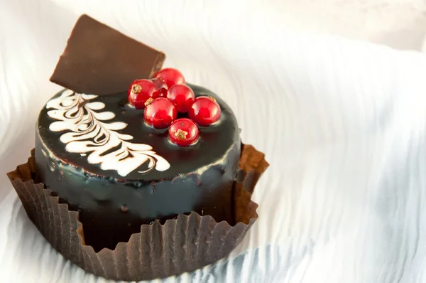 Stock image Chocolate cake with a red currant, coffee and cream