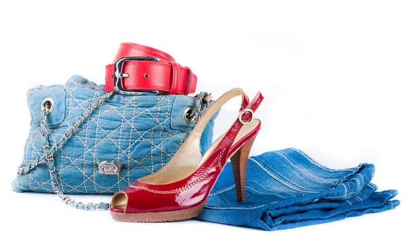 Red belt and shoes, a jeans bag and a skirt on a white background — Stock Photo, Image