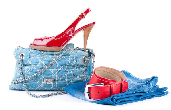Red belt and shoes, a jeans bag and a skirt on a white background — Stock Photo, Image