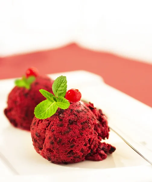 stock image Ice-cream globule with a currant and mint on a red napkin