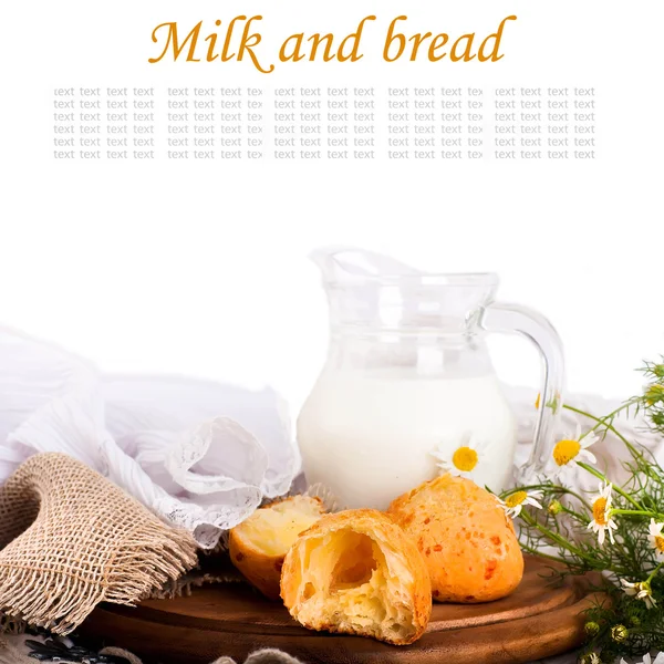 stock image Jug with milk, bread and wild flowers on a white background