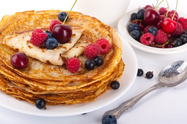 Pancakes with berries on a white background clipart