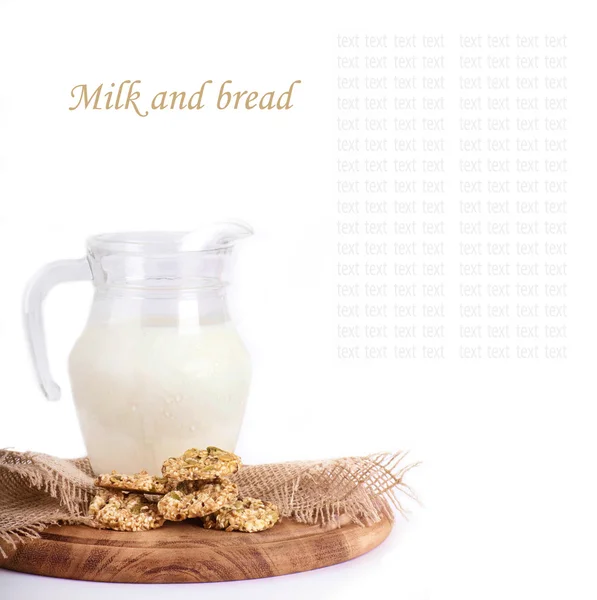 Jug with milk, bread on a white background — Stock Photo, Image