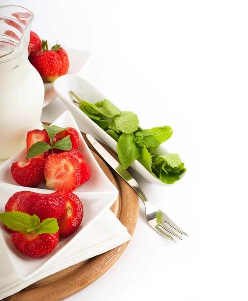 Strawberry with a mint and jug of milk on a white serviette — Stock Photo, Image