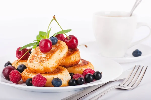 Сырные блинчики с лесными ягодами и чашечкой кофе — стоковое фото