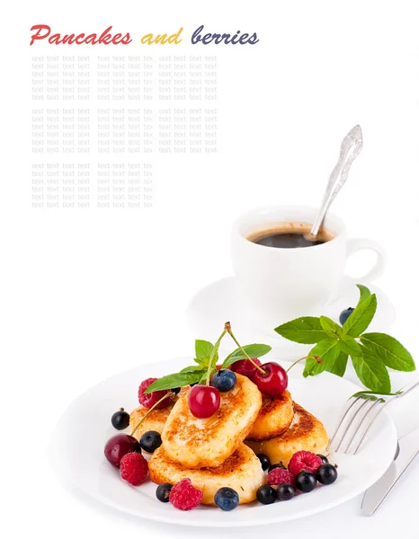 stock image Cheese pancakes with forest berries and cup of coffee