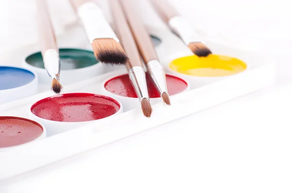 Pencils, paints and brushes on a white background — Stock Photo, Image
