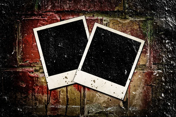 Photo frames on old brick wall — Stock Photo, Image