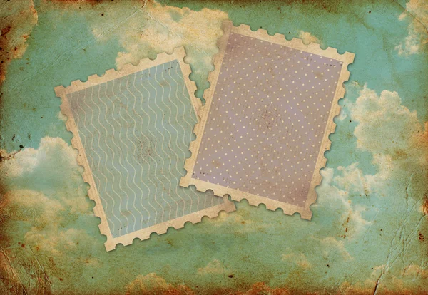 Zwei alte Briefmarken auf einem alten Foto vom Himmel — Stockfoto