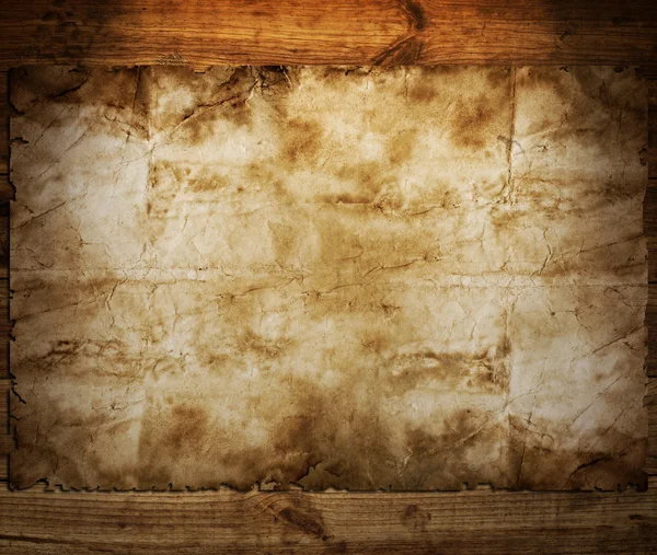 Old paper on brown wood texture — Stock Photo, Image