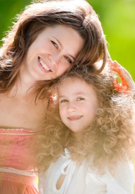 Young mother hugging her daughter