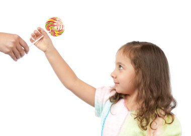 Happy little girl taking candy from her mother clipart