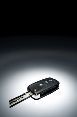 Car key on dark background clipart