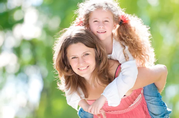 Beautiful mother and daughter playing — Stock Photo, Image