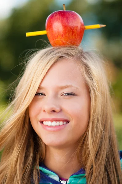 Νεαρός φοιτητής κορίτσι με το μήλο στο κεφάλι της — Φωτογραφία Αρχείου