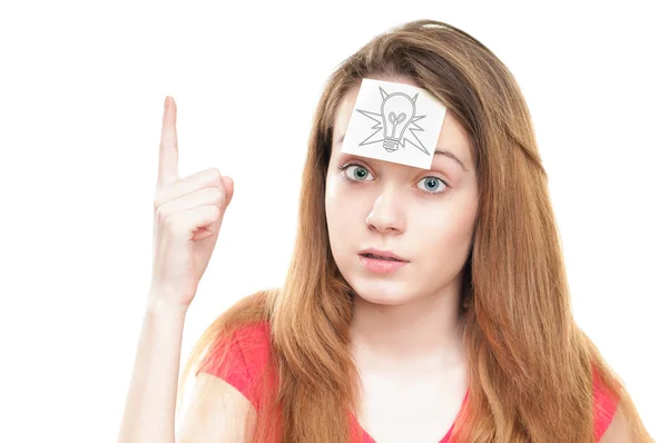 Girl with light bulb on paper on her forehead. — Stock Photo, Image