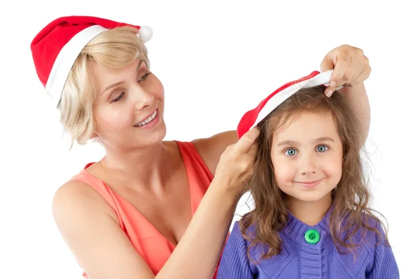 Mutter und Tochter gemeinsam in Weihnachtsmützen — Stockfoto