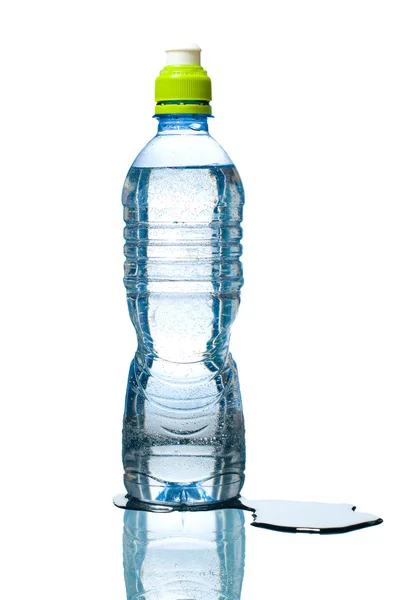 Bottle of water with puddle besides — Stock Photo, Image