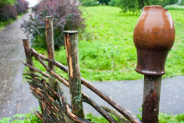 Pot on fence — Stock Photo, Image