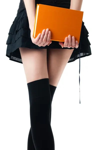 Woman in skirt and stockings with book — Stock Photo, Image