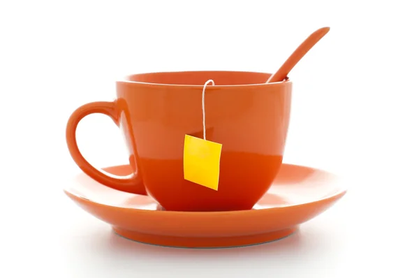 Xícara de laranja com saco de chá — Fotografia de Stock