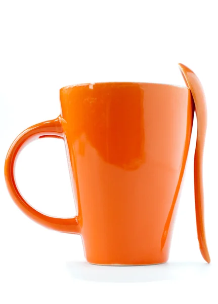 Orangefarbene Tasse und Löffel — Stockfoto