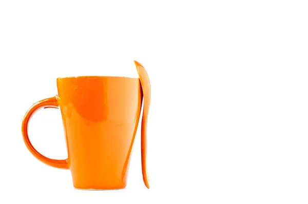 Апельсиновая чашка и ложка — стоковое фото