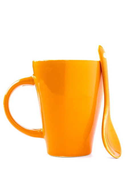 Pomarańczowy kubek i łyżka — Zdjęcie stockowe