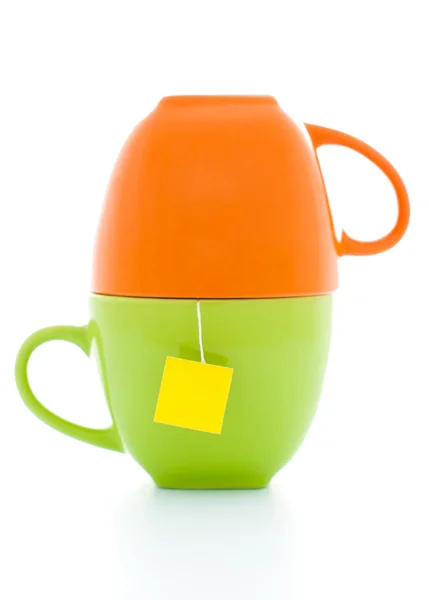 Tasses à thé orange et vert avec sachet de thé — Photo