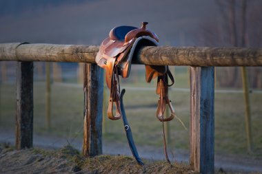 Western Saddle on Fence clipart