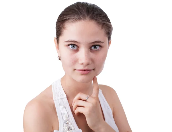 Serious young woman keeps his finger near the cheeks isolated on white — Stock Photo, Image