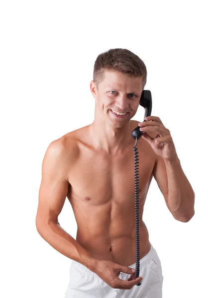 Jovem sorri e fala por telefone isolado em branco — Fotografia de Stock