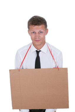 Businessman with an empty cardboard sign on his chest clipart