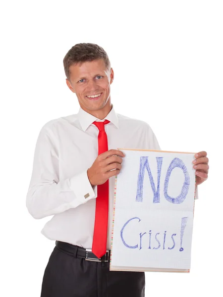 Portrait of a young businessman smiling and holding a sign — Stock Photo, Image