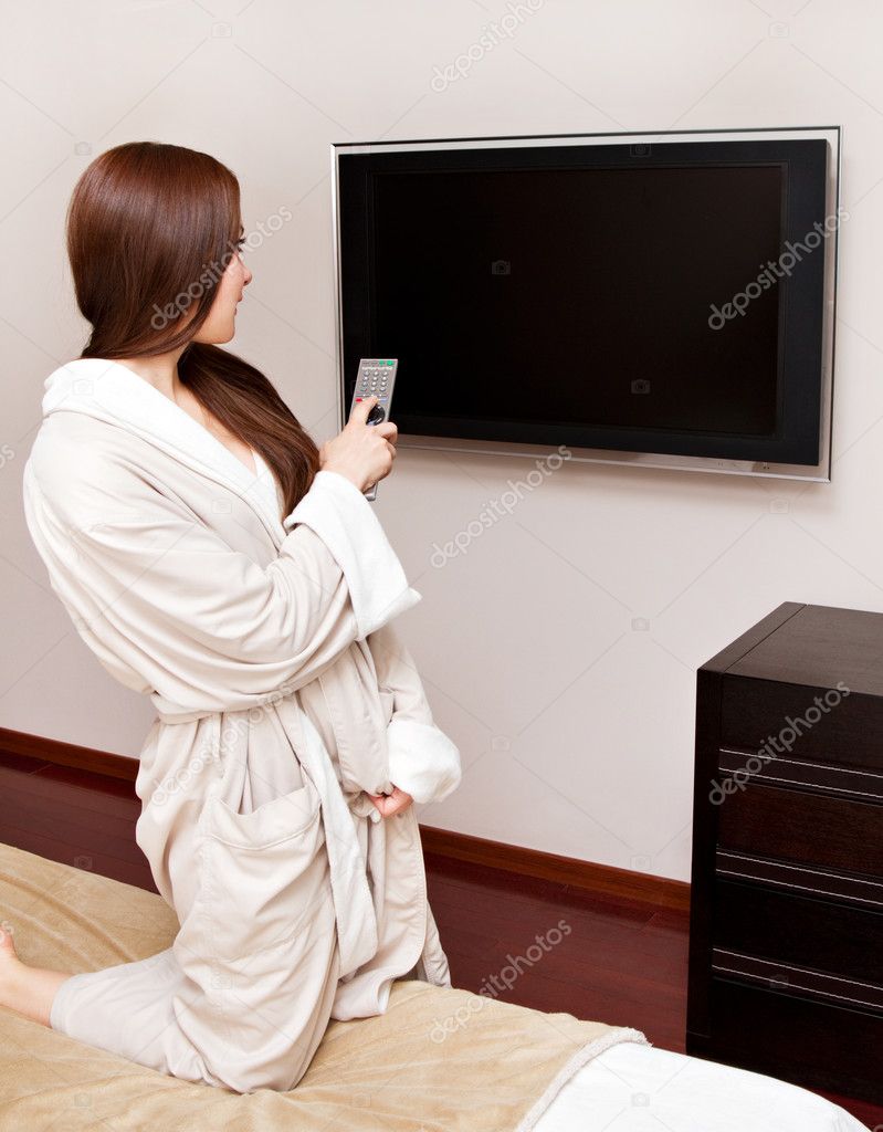 Attractive woman watching TV