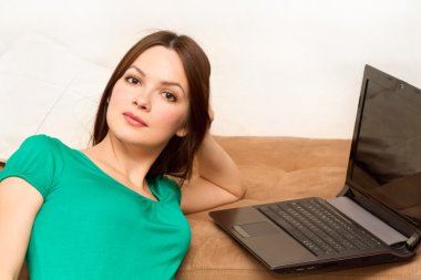 Woman on the floor with laptop clipart