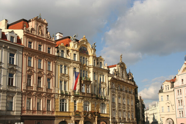 Monumental houses and Czech flag on Prague Town Square