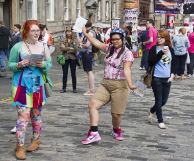 Girls handing out flyers at Edinburgh Festival clipart