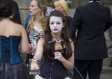 Girl handing out flyers at Edinburgh Festival clipart