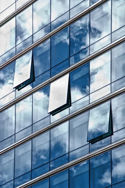 stock image Sky and clouds reflected in windows of a building